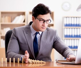 Businessman with dominoes in the office
