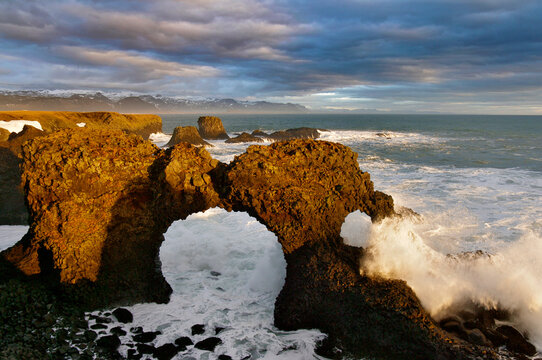 Waves crashing on sea arch at Arnastapi, Snaefellsnes peninsula, Iceland