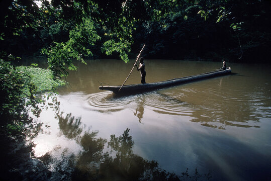 Two men in a hollowed out canoe, Zaire.
