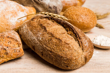 Homemade natural breads. Different kinds of fresh bread as background, perspective view with copy space