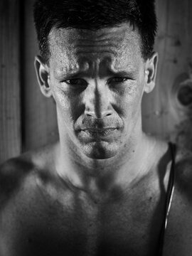 Black and white portrait of a man sweating  after a workout.