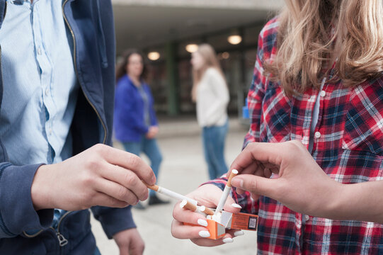 University students smoking cigarettes in campus, Bavaria, Germany