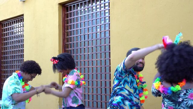 Friends dancing at the carnival in the street