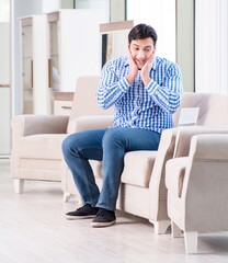 Young man shopping in furniture store