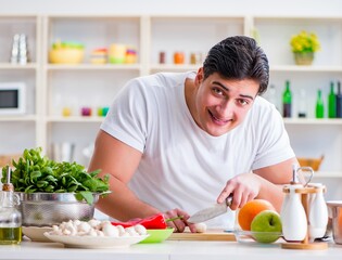 Young male cook working in the kitchen