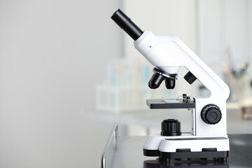 Modern medical microscope on metal table in laboratory