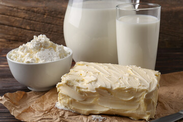 Tasty homemade butter and dairy products on wooden table, closeup
