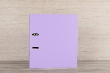 Lilac hardcover office folder on white wooden table