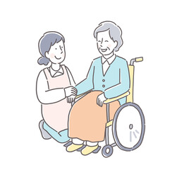 笑顔で話す車椅子の女性と介護スタッフ