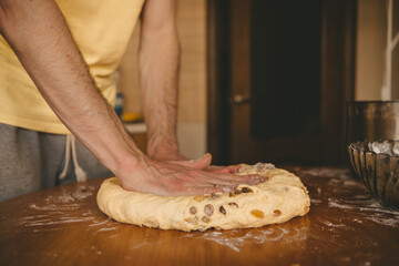 male hands knead the dough