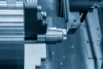 The  CNC lathe machine forming  cutting the metal shaft parts.