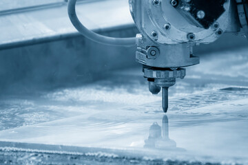 Close-up scene of multi-axis abrasive waterjet cutting machine cutting the aluminum plate.