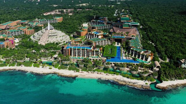 Flying high around the beautiful Xcaret Arte Resort and the tropical beach in Playa del Carmen, Quintana Roo, Mexico. Aerial drone of  beach luxury resort.