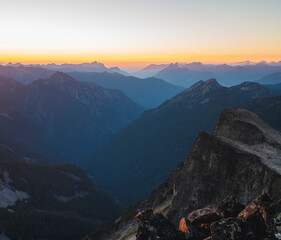 Fototapeta na wymiar Sunset across layers of mountain peaks in the Alpine Lakes Wilderness