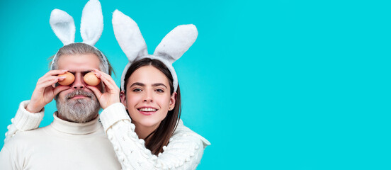 Easter couple on blue background isolated. Panoramic web banner frame.