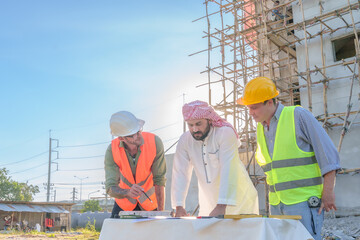 Diverse team of professionals using tablet computers on construction site. Real estate construction project. with civil engineers, architects, Arabic business investors and explorer with theodolite