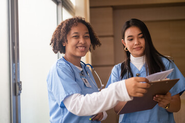 Nurse student Multi-ethnic group of happy nursing students talking medical university corridor.