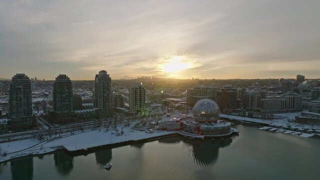 Vancouver Canda covered in winter snow - Science World ASTC building Downtown Area - Drone Aerial Sunset Shot
