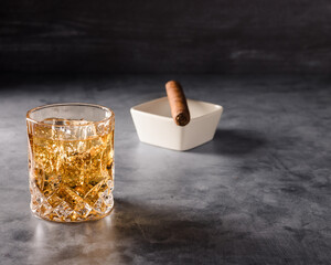 glass of whiskey with ice on a wooden background