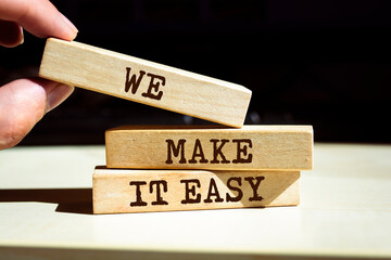 Wooden blocks with words 'We make it easy'. Business concept
