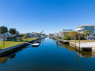 Fototapeta na wymiar Calm Canal with houses and docks and boats near Tampa Florida by the Gulf of Mexico