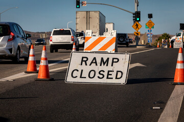 Traffic caused by a sign and cones indicating a freeway onramp is closed - obrazy, fototapety, plakaty
