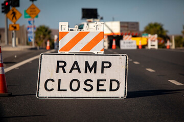 Traffic caused by a sign and cones indicating a freeway onramp is closed