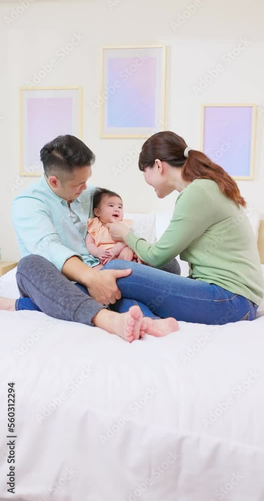 Poster young parents play with baby