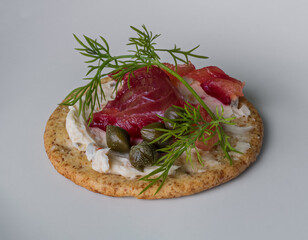cured salmon on top of a cookie in fancy presentation 