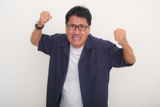 Asian man, standing in casual clothes looking frustrated and anxious
