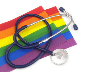 Blue stethoscope on LGBT flags isolated on white background. Medical support after sex reassignment surgery.