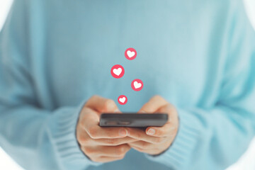 Happy woman enjoy fun chat typing on smart phone relax watch live video and post button love heart emoji icon, Social media, social network concept
