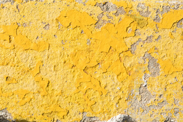 Weathered grunge rough old yellow paint on the wall
