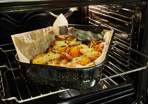 Potatoes With Sweet Potatoes Are Baked In The Oven On Baking Sheet