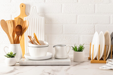 front view of the marble white countertop with various kitchen utensils made of natural materials. ecologically clean house. zero waste.