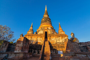 Fototapeta premium Buddha statues in front of Pagoda at Wat Yai Chai Mongkhon, Ayutthaya, Thailand, Unesco World Heritage Site.