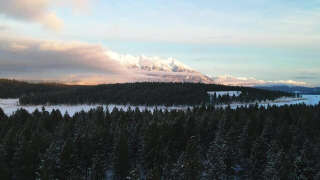 Winter Wonderland: A Sunset Aerial View of Snowcapped Mountains in British Columbia