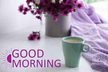 Good morning! Cup of aromatic coffee, beautiful flowers and violet cloth on white table