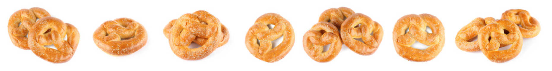 Set with tasty freshly baked pretzels on white background. Banner design