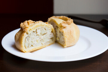 Pirozhki​ are stuffed rolls typical of Russian, Belarusian, and Ukrainian cuisines. They can be baked or fried with yeast. Their fillings are made of meat or vegetables.