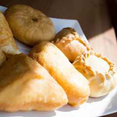 Pirozhki​ are stuffed rolls typical of Russian, Belarusian, and Ukrainian cuisines. They can be baked or fried with yeast. Their fillings are made of meat or vegetables.