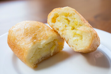 Pirozhki​ are stuffed rolls typical of Russian, Belarusian, and Ukrainian cuisines. They can be baked or fried with yeast. Their fillings are made of meat or vegetables.