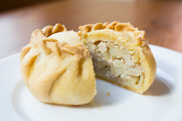 Pirozhki​ are stuffed rolls typical of Russian, Belarusian, and Ukrainian cuisines. They can be baked or fried with yeast. Their fillings are made of meat or vegetables.