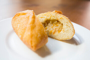 Pirozhki​ are stuffed rolls typical of Russian, Belarusian, and Ukrainian cuisines. They can be baked or fried with yeast. Their fillings are made of meat or vegetables.