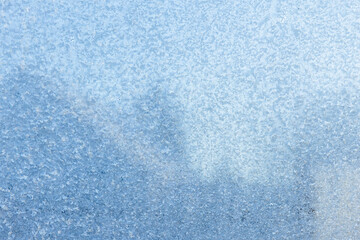 Fototapeta na wymiar Frost on a window glass, closeup abstract background photo texture