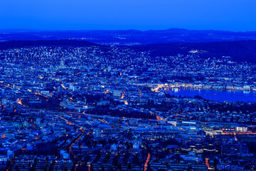 Swiss city Zürich in blue hours with the town center at the Zurich Lake on the right - viewd from the Uetliberg