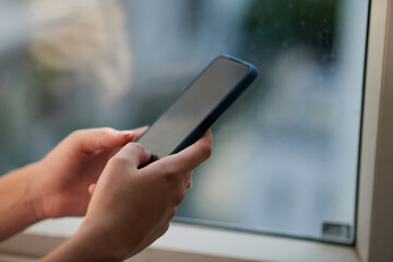 Closeup image of woman answering text mesages on smartphone