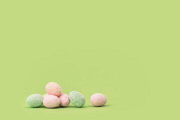Happy Easter minimal concept. many tiny eggs sweets on spring yellow green edgeless background. Easter chocolate treats web banner