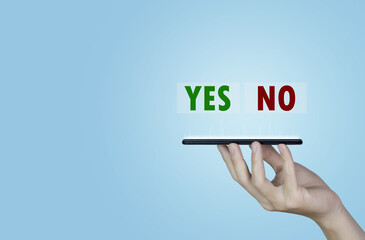 Businessman holding smartphones showing yes or no