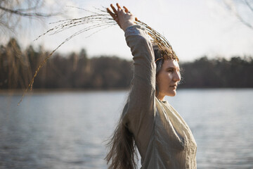 Close up authentic woman running hand up willow twigs crown portrait picture. Closeup side view...